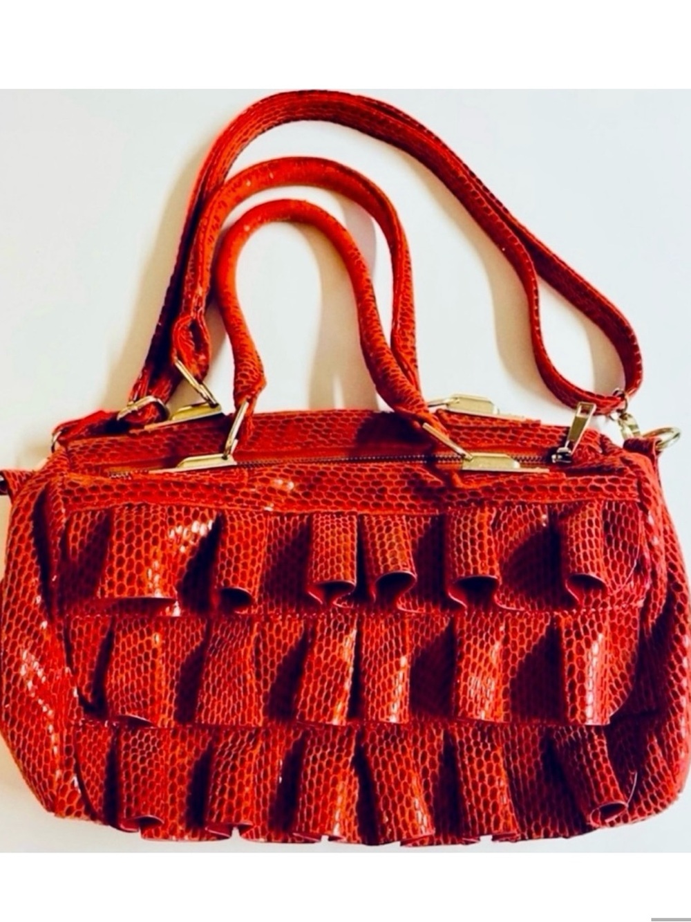 Mellow World-Red Ruffle Maximalist shoulder bag with snake print & extra strap.